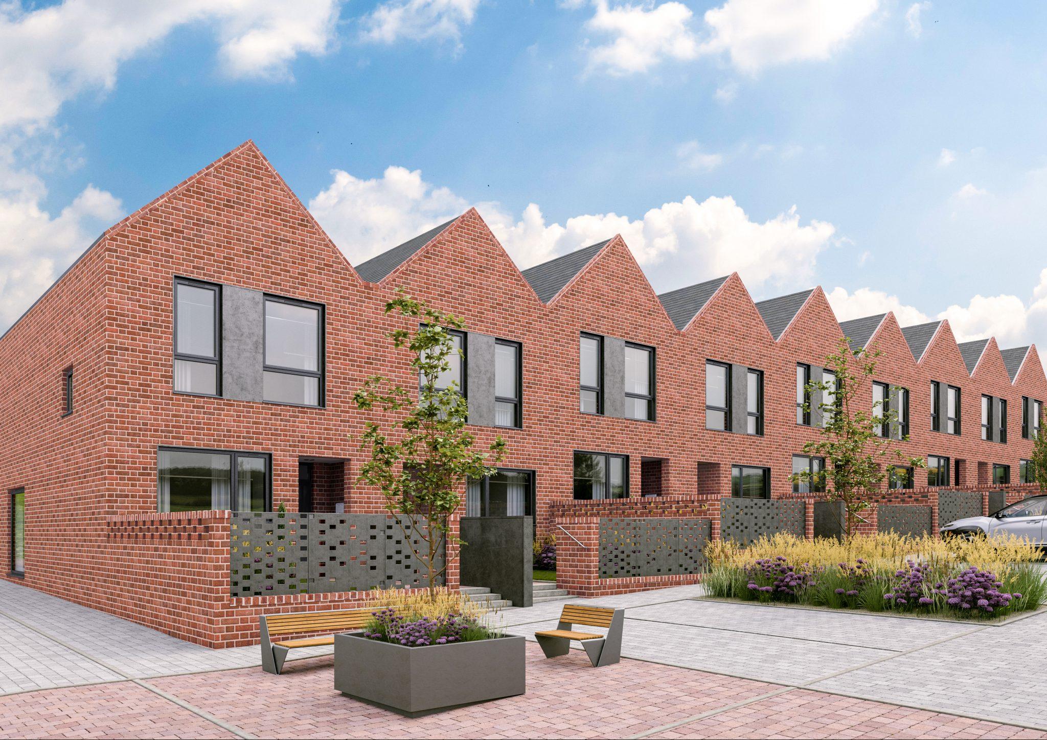Row of new build houses in red brick on a clear day